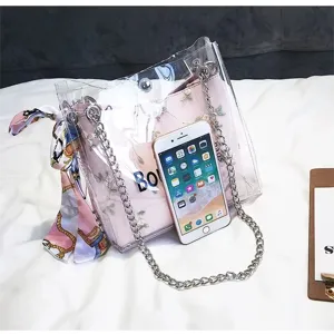 Transparent PVC jelly crossbody bag with pink embroidered inner pouch, chain strap and scarf.