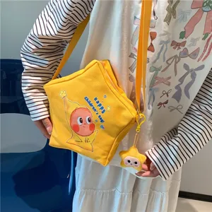 Cute yellow star crossbody canvas bag with cartoon print and cute pendant for daily use.