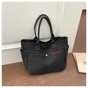 Large capacity black canvas tote bag, versatile Korean style shoulder bag with zipper and pockets.
