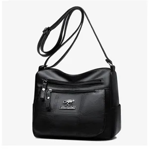 Black PU leather multi-layer crossbody bag detail showcasing smooth zipper pockets and strap.