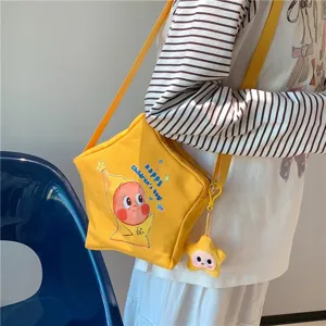 Yellow star shaped canvas crossbody bag featuring cute cartoon print and matching star pendant.