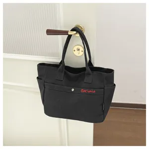 Black canvas tote bag hanging detail shot, casual style daily handbag for women chic style.