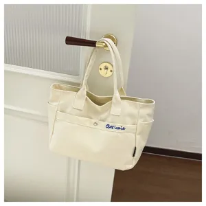 Casual canvas tote bag with large capacity, stylish shoulder handbag for daily student use.