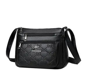 Black soft leather crossbody bag featuring multiple zipper pockets and elegant bow quilted pattern.