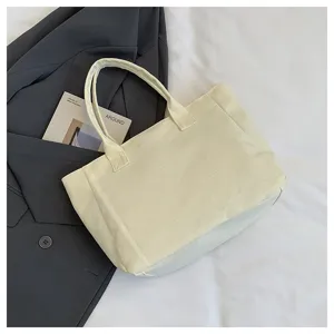 Casual minimalist canvas tote bag for daily commute, solid color beige shoulder handbag.