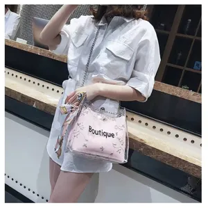 Clear detail view of the clear PVC jelly crossbody bag with pink lining, cute embroidery and chic strap.