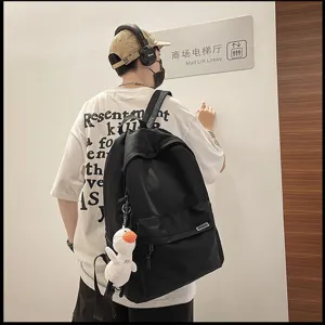 Casual black backpack for men and women, large capacity travel school bag for students daily use.