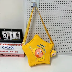 Cute star canvas crossbody bag, bright yellow cartoon shoulder bag with star pendant.