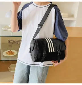 Black nylon messenger bag for women, casual commuter crossbody bag with three white stripes.