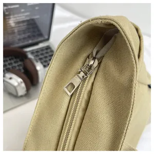 Close-up detail of beige canvas bag zipper, durable fabric and smooth metal closure.