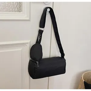 Black oxford cloth cylindrical pillow shoulder bag detail, casual crossbody bag with small pouch.