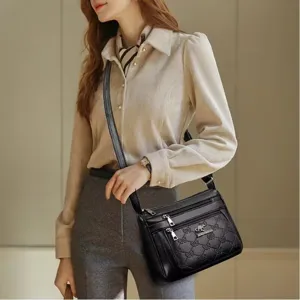 Classic black leather women's shoulder bag with multi-pocket design and elegant bow pattern.