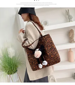 Canvas leopard print tote bag with cute plush pendant, stylish casual handbag for women.