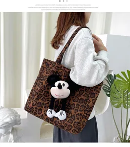 Leopard print canvas tote bag featuring cute cartoon mouse plush toy accessory close up view