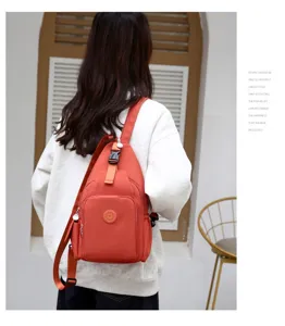 Detail shot of orange waterproof oxford cloth chest and backpack, multi-compartment design.