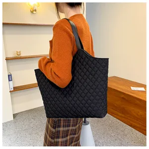 Detail view of a black quilted tote bag, large capacity nylon shoulder bag for women autumn.