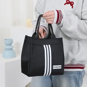Black canvas tote bag with stylish white stripes and top handles for daily commute and lunch.