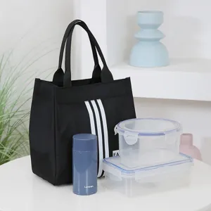 Black canvas lunch bag with white stripes, spacious tote handbag designed for daily office commute.