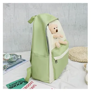 Green and beige canvas backpack with cute plush bear doll, Japanese style school bag for girls.