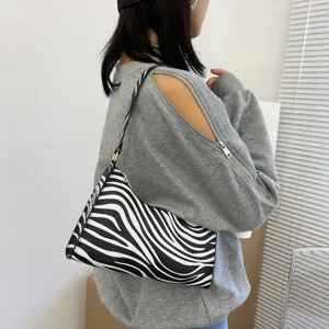 Detailed view of the stylish zebra print underarm bag, showcasing fine PU leather and texture.