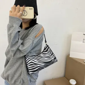 Stylish black and white zebra print shoulder bag for women, trendy minimalist underarm bag.
