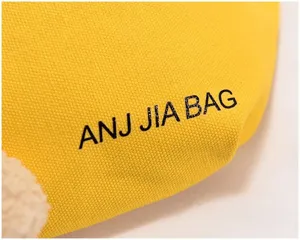 Close-up detail of the yellow canvas bag showcasing clear fabric texture and cute print.