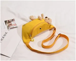 Yellow canvas chest bag featuring a cute plush bear detail, adjustable strap and secure zipper.