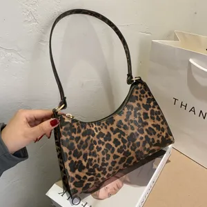 Vintage leopard print shoulder bag for women, chic baguette handbag with strap and zipper.