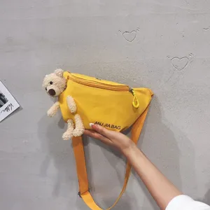 Cute yellow canvas waist bag for women with adorable plush teddy bear, casual chest crossbody.