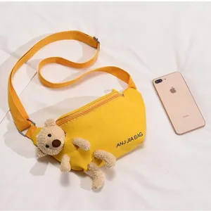 Cute yellow canvas crossbody chest bag for women with adorable plush teddy bear charm daily use.