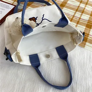 Cute canvas shoulder bag for women casual Japanese style tote with plush bear charm and blue straps.