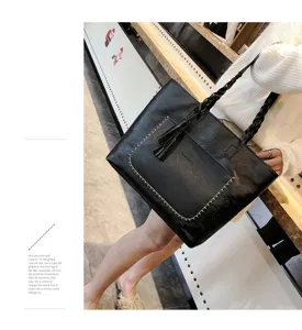 Stylish women tote bag with tassel design, large capacity black PU leather shoulder handbag.