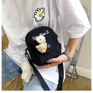 Canvas cross-body phone bag featuring cute cartoon bear plushie design, detailed view.
