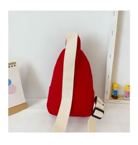 Red canvas sling bag detail view, casual teardrop chest bag for kids, daily streetwear look