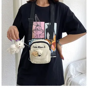 Canvas crossbody bag for women with cute bear pendant, casual messenger shoulder cell phone bag.