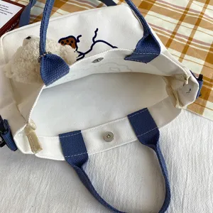 Canvas tote bag with cute plush bear pendant, blue straps and shoulder crossbody design.