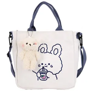 Cute canvas tote bag for women casual crossbody shoulder bag with cute plush bear pendant.