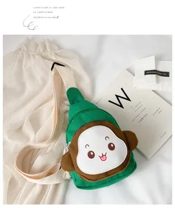 Cute green canvas chest bag for kids, featuring a playful cartoon monkey face and strap.