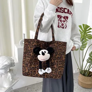 Leopard canvas tote bag with cute cartoon plush charm, large capacity casual handbag.
