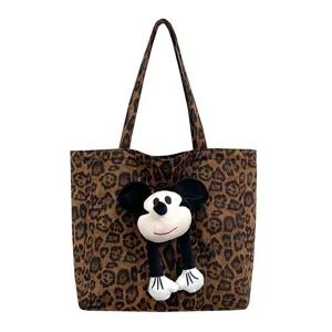 Leopard print canvas tote bag, large capacity casual commuter handbag with plush doll decor.