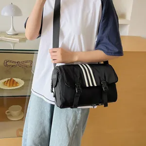 Black nylon crossbody bag with three white stripes, casual sports messenger bag for daily commuting.