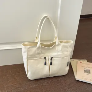Minimalist canvas tote bag for women, Japanese style commuter handbag with zipper and front pockets.
