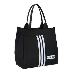 Black canvas handbag featuring three white stripes and a fashion label, ideal for daily commute.