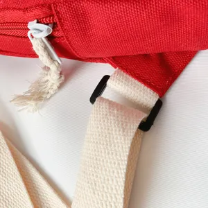 Red canvas chest bag detail, cute children crossbody bag strap, durable hardware and zipper.