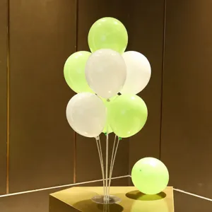 Green and white balloon table stand kit detail shot, showing assembly and components clearly.