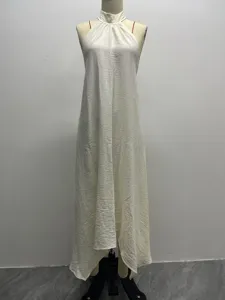 Details of the solid color halter neck maxi dress with textured wrinkled fabric design.