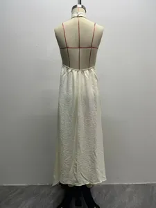 Backless halter long dress detail showcasing unique textured fabric and smooth drape.