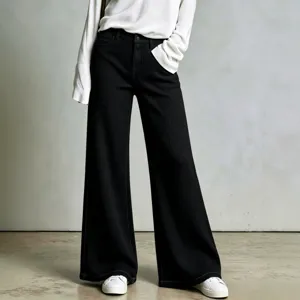 Detailed view of women's black waffle knit wide-leg pants showing texture and fit.