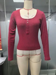 Detailed view of the dark red knitted long-sleeve top with lace trim and front buttons.