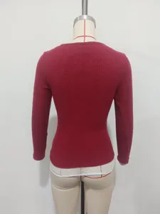 Back view of the women's slim-fit long-sleeve knit top featuring a delicate lace hem.